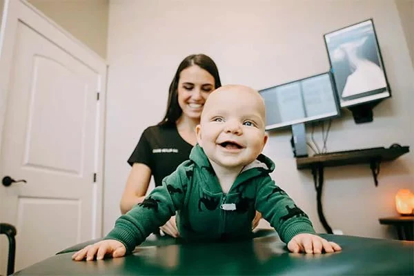 A smiling baby during a visit at Advanced Collective